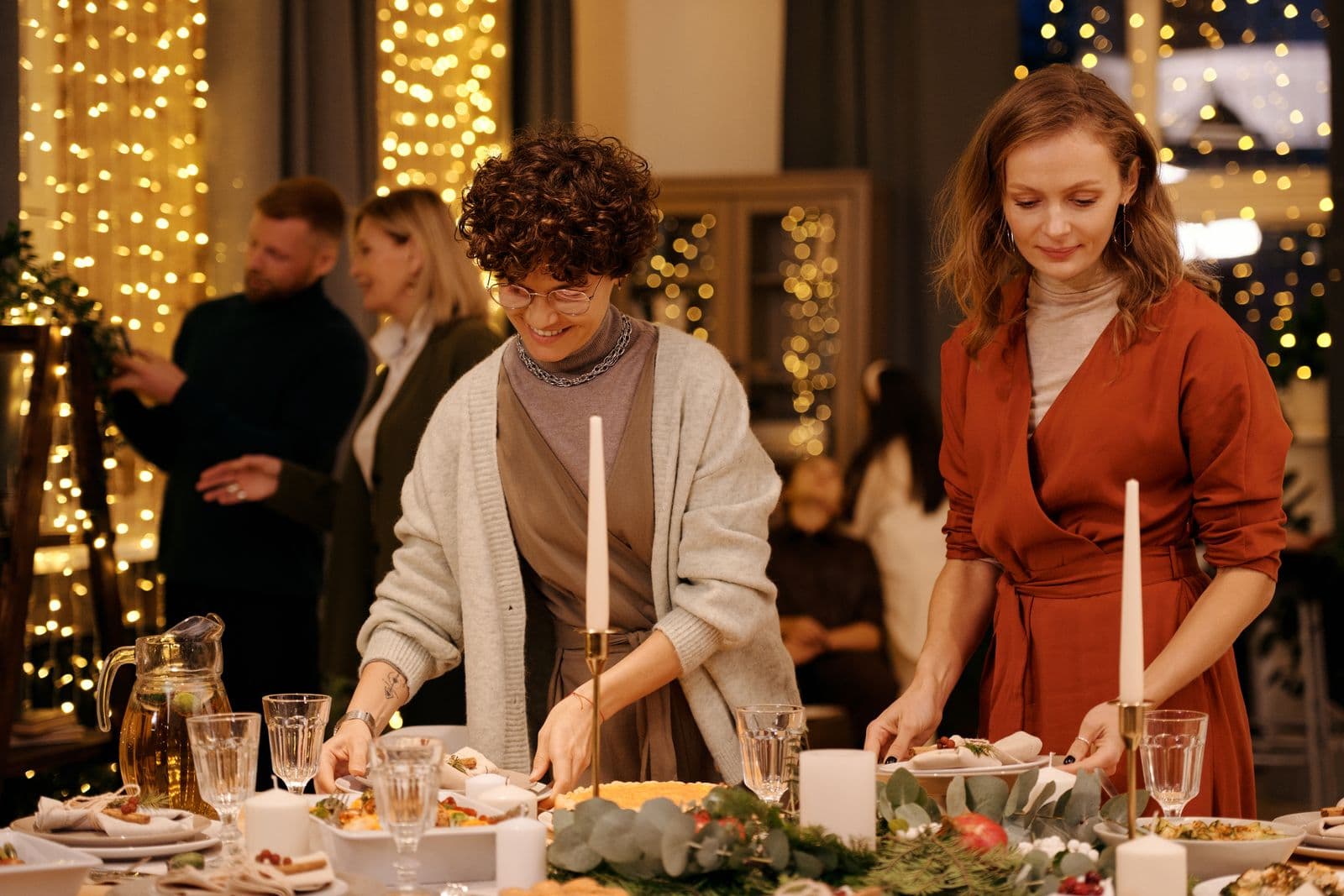 Friends setting a festive table for a dinner party